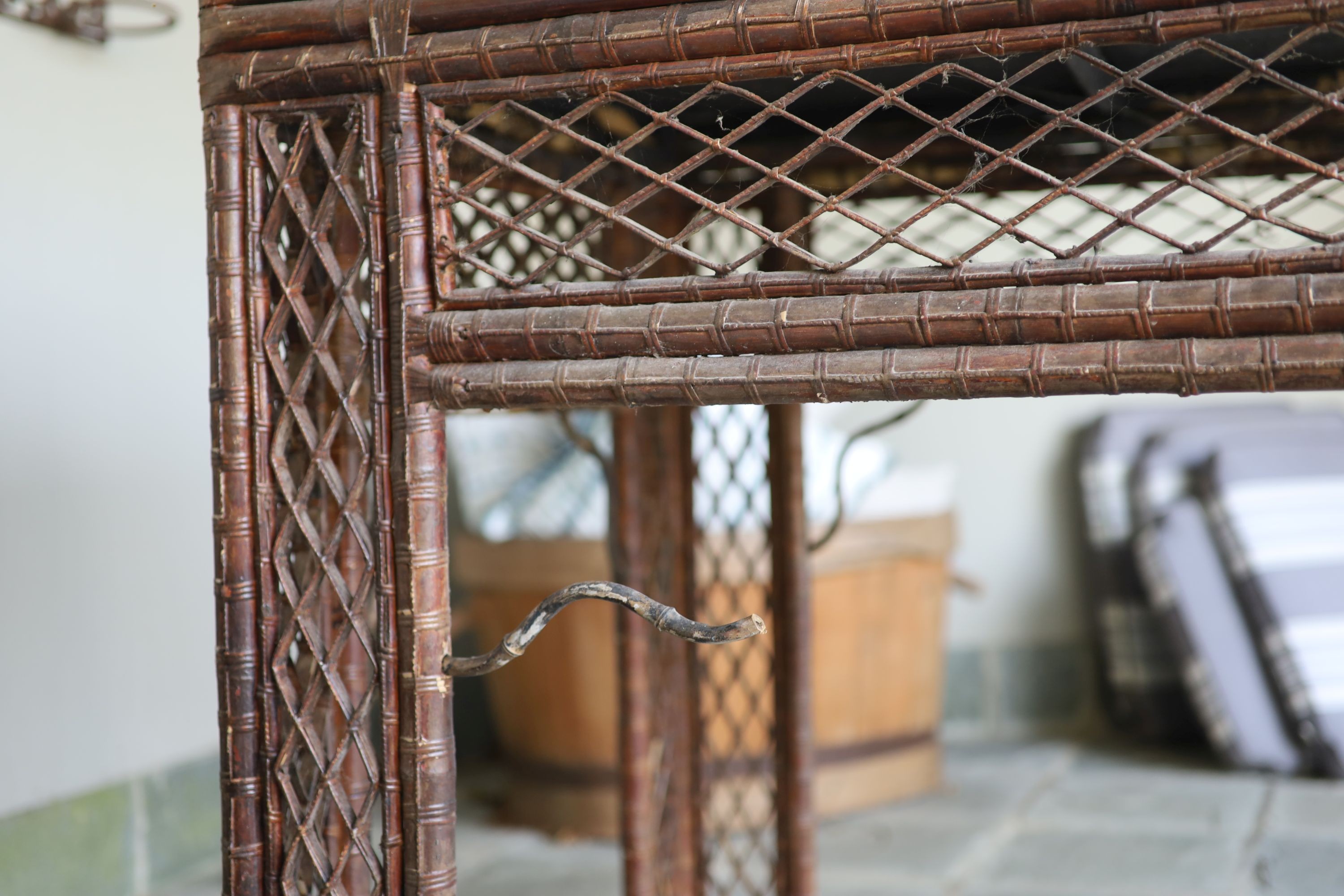 A bamboo and rattan centre table, with black lacquered top, width 166cm depth 76cm height 86cm